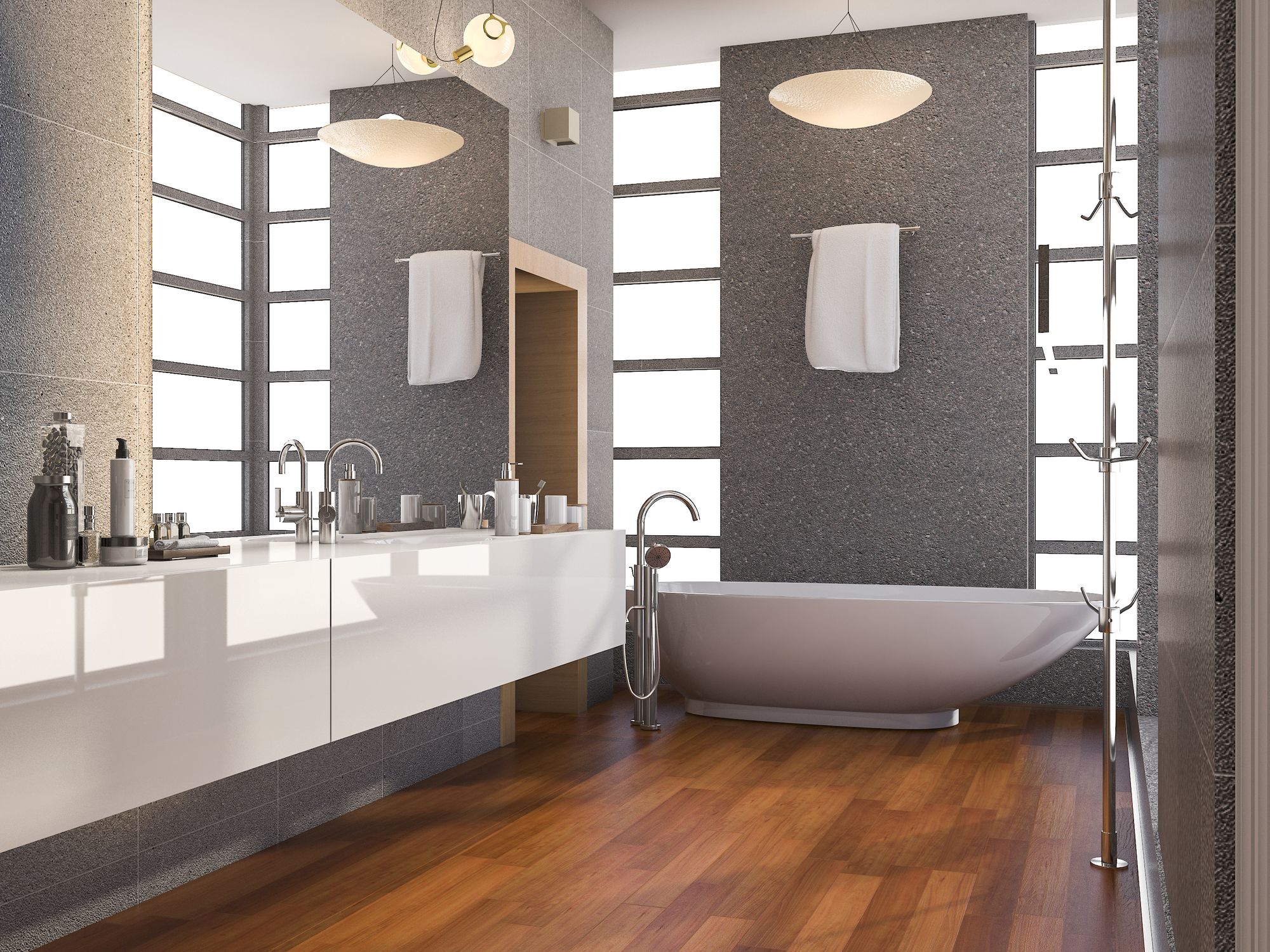 A modern bathroom with gray walls, white countertops, wide cabinets, and a white freestanding tub.