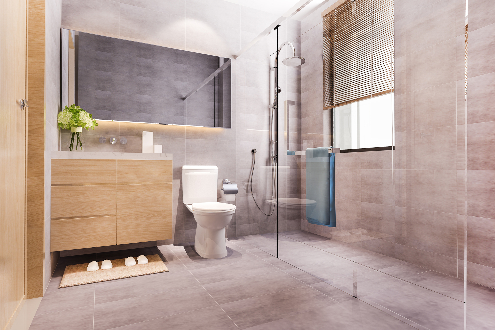 A modern bathroom with a wood vanity, white toilet, and a glass walk-in shower.