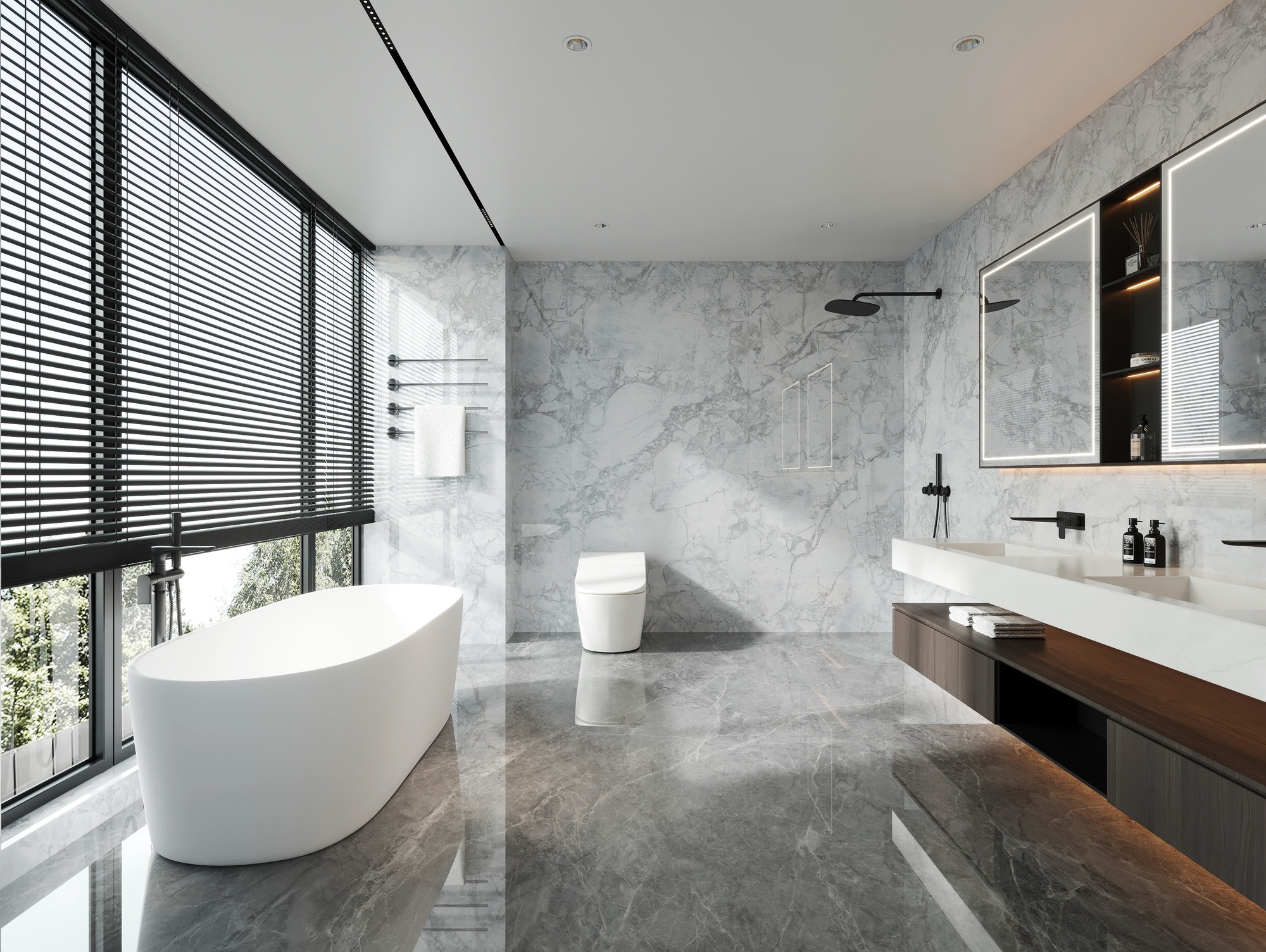 A modern bathroom with gray walls, a white freestanding bathtub, a white toilet, a long vanity with mirrors above it, and a black showerhead.