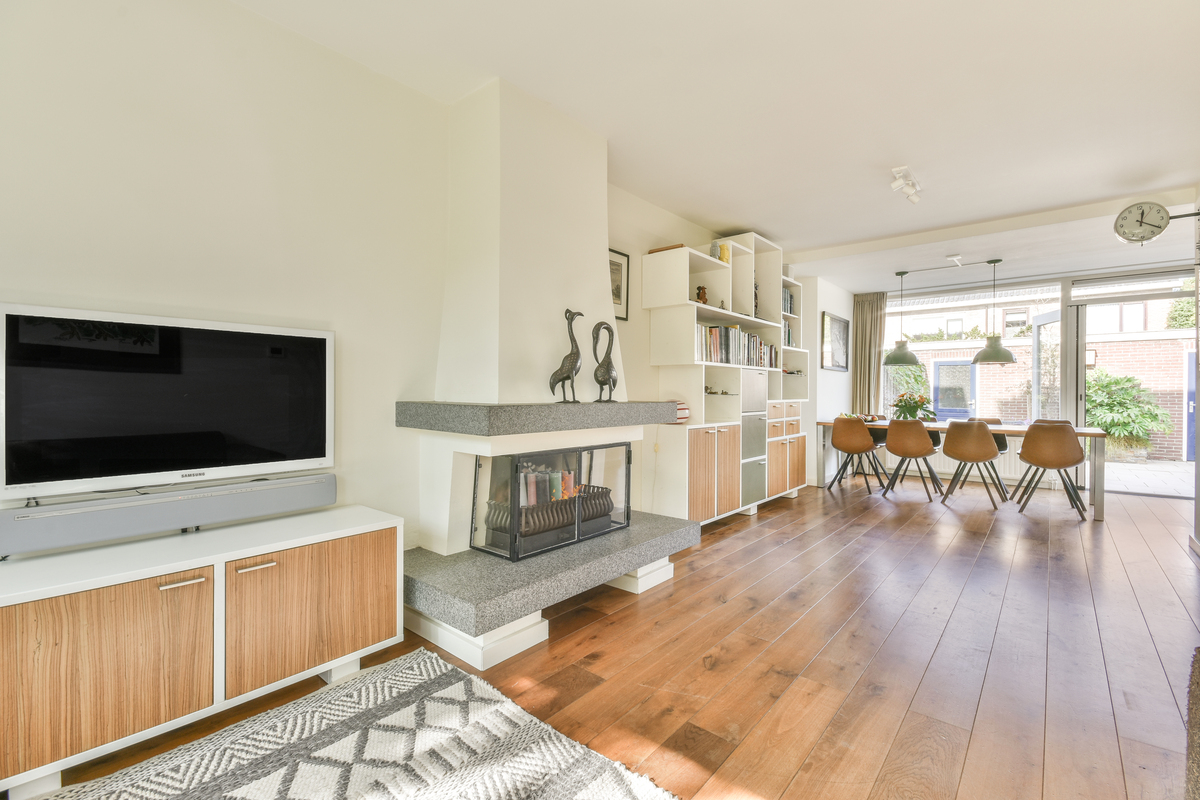 Expert Home Remodeling Services | San Pedro, CA | EGM Construction A bright, open-concept living and dining space features rich hardwood flooring, custom built-in shelving, and a modern fireplace that highlights a comprehensive home remodeling project.